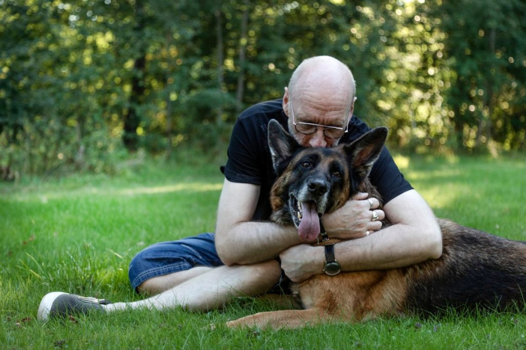 img_2642-e1720706475107 Man hugging German Shepherd dog suffering from osteosarcoma.